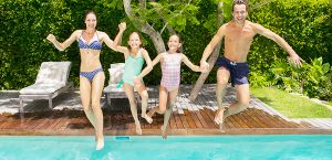Family Jumping into Swimming Pool